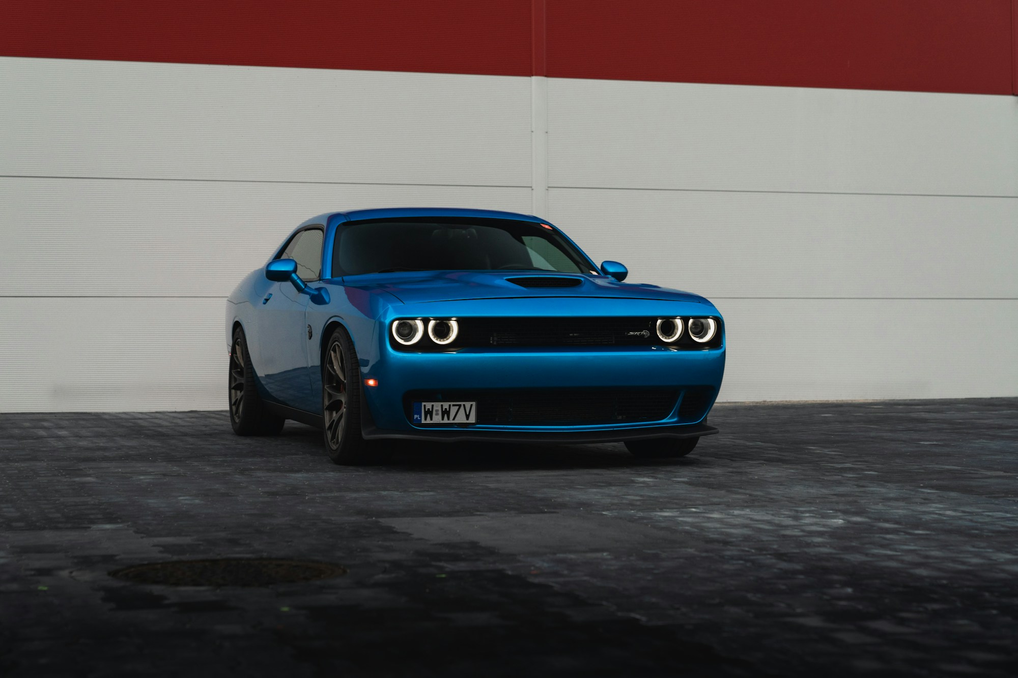 Blue Dodge Challenger SRT Hellcat with illuminated headlights